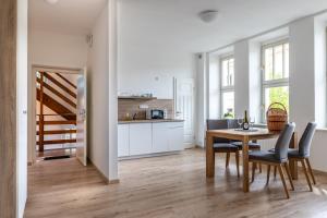 a kitchen and dining room with a table and chairs at Villa Wurmfeld in Český Krumlov