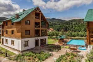 an aerial view of a house with a pool at Edelweiss Carpathians Migovo in Migovo