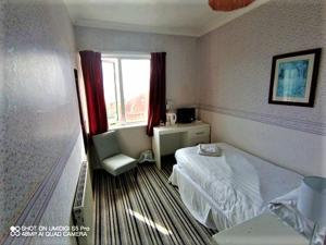 A bed or beds in a room at The Wight Bay Hotel 