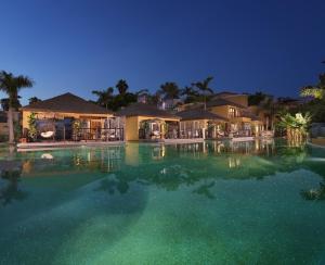 a large swimming pool in a tropical setting at Royal River, Luxury Hotel - Adults Only in Adeje