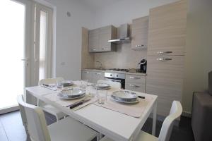 a kitchen with a table with plates and glasses on it at Puglia casa vacanza in Ginosa Marina