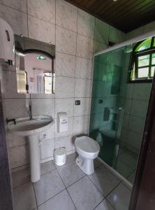 a bathroom with a sink and a toilet and a shower at Pousada Bob Pai & Bob Filho in Ilha do Mel