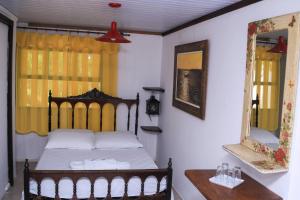 Cama ou camas em um quarto em Pousada Bob Pai & Bob Filho