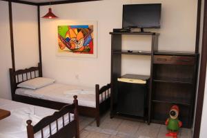 Cama ou camas em um quarto em Pousada Bob Pai & Bob Filho