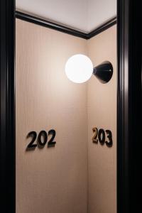 a room with a door with a light and signs at The Hunfeld in Utrecht