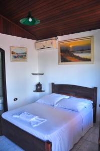 Cama ou camas em um quarto em Pousada Bob Pai & Bob Filho