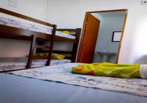 a bedroom with two bunk beds and a mirror at Pousada Brasil - Self Check-in in Aparecida