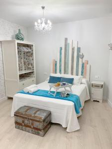 a bedroom with a bed with a table on it at Apartamentos Rincón de Cantarranas in Alhama de Aragón