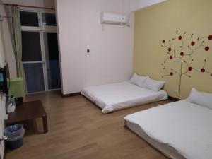 Postel nebo postele na pokoji v ubytování Hualien Travel