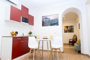 une cuisine avec une table et des chaises dans une pièce dans l'établissement Dreaming in Rome - Vittorio Veneto Guest House, à Rome