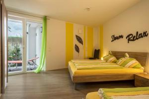 a bedroom with two beds and a balcony at Ferienwohnung Jasmin in Sipplingen