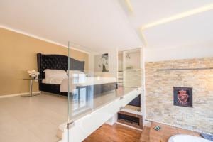 a bedroom with a bed and a brick wall at Jacuzzi Andrassy Avenue in Budapest