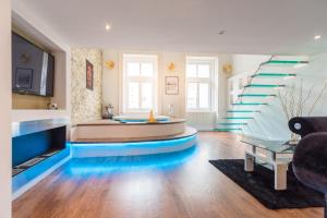 a living room with a staircase with blue floors at Enzo Capo Jacuzzi Andrassy in Budapest