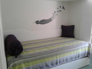 a bedroom with a bed with birds on the wall at U' Pizzico ( the pinch ) in Capri