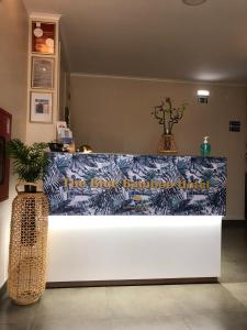 a counter in a room with two vases on it at The Blue Bamboo Hotel - Duna Parque Group - "Ex Casa dos Arcos" in Vila Nova de Milfontes