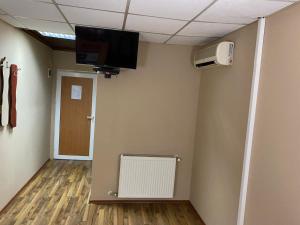 a room with a fan and a tv on a wall at Motel Dilijans in Vidin +12 photos