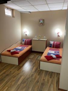 a room with two beds and a counter at Motel Dilijans in Vidin