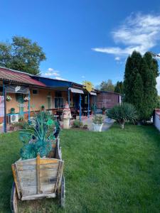 a wooden cart sitting in the grass in front of a building at Motel Dilijans in Vidin