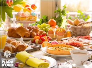 a table topped with plates of food and pastries at Hotel Piada D'Oro in Riccione +26 photos