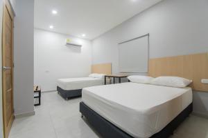 Stanza Hotel Sincelejo客房内的一张或多张床位