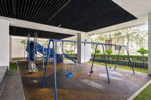 a playground in a building with blue swings at Puchong Setiawalk Residence By Iconique Espace in Puchong