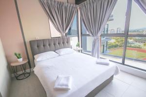 a bedroom with a large bed with a large window at Bell Suites by Salaam Suites, Sepang in Sepang +52 photos