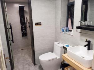 a bathroom with a toilet and a sink at A&G Apartment in Zhangjiajie