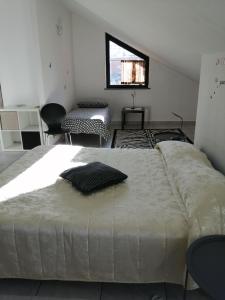 a large bed in a room with chairs and a window at CAMERA 4b in Aosta