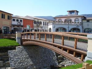 a wooden bridge over a river in a town at Little Liberty Loft in Barberino di Mugello