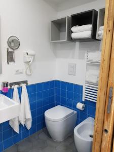 a blue and white bathroom with a toilet and a sink at Bed & Breakfast Portanova in Naples