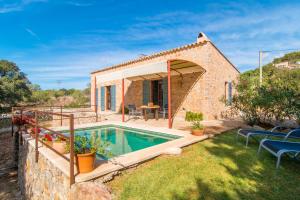a small house with a swimming pool in a yard at Finca Bonita in Son Servera