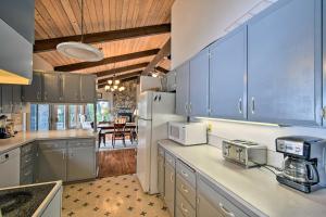 a kitchen with blue cabinets and a counter top at Quiet Beachfront Family Home with Mt Rainier Views! in Shelton