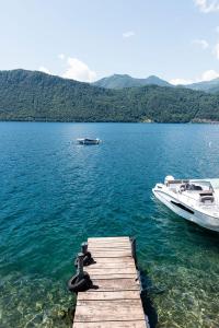 a boat is docked at a dock on a lake at Giardinetto in Pettenasco