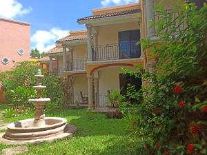 a house with a fountain in front of it at Ecotel Quinta Regia in Valladolid