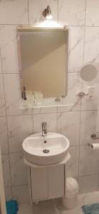 a white bathroom with a sink and a mirror at Ferienwohnung Labahn in Ahlbeck