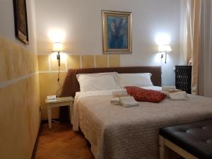 a bedroom with a bed with two pillows on it at Cittadella in Verona