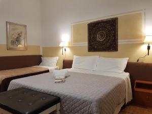 a hotel room with two beds and a table at Cittadella in Verona