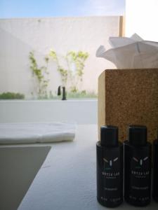 a group of three bottles of hair products sitting next to a counter at Quinta Da Comporta - Wellness Boutique Resort in Comporta