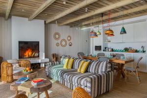 a living room with a couch and a fireplace at Quinta Da Comporta - Wellness Boutique Resort in Comporta