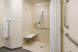 a bathroom with a shower stall and a toilet at Candlewood Suites - Orlando - Lake Buena Vista, an IHG Hotel in Orlando