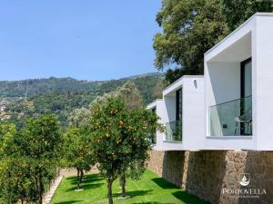 a house on a hill with an orange tree at Portovella Lodges & Bungalows in Pala