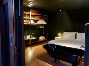 a bedroom with a bed and a bath tub at Casa da Horta in Peso da Régua