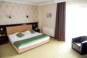 a bedroom with a bed and a television at Curtea Bizantina in Suceava