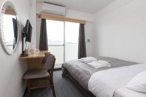 Voodi või voodid majutusasutuse Global Resort Miyajima View toas