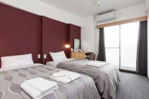 Voodi või voodid majutusasutuse Global Resort Miyajima View toas