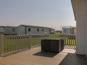 a trash can sitting on the deck of a house at Daisy Lodge in Scarborough