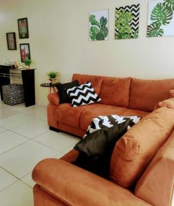 a living room with two couches with pillows on them at Apto 2 quartos em Arroio do Silva in Arroio do Silva
