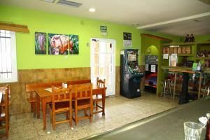 a restaurant with a table and a video game at Hostal Asturias in Jarilla