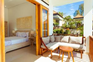 a bedroom with a bed and a couch and a table at Villa Jempana Kintamani in Kintamani