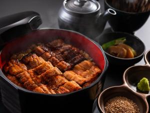 a pan filled with meat and other foods on a table at ART HOTEL Miyazaki Sky Tower in Miyazaki +88 photos